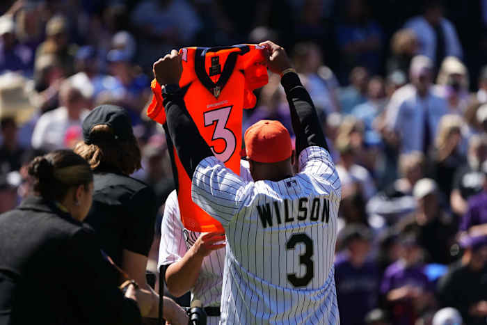 Apr 8, 2022; Denver, Colorado, USA; Denver Bronco quarterback Russell Wilson (3) before the game between the Los Angeles Dodgers against the Colorado Rockies at Coors Field. Mandatory Credit: Ron Chenoy-USA TODAY Sports